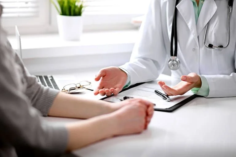 Doctor talking to a patient in a medical consultation.