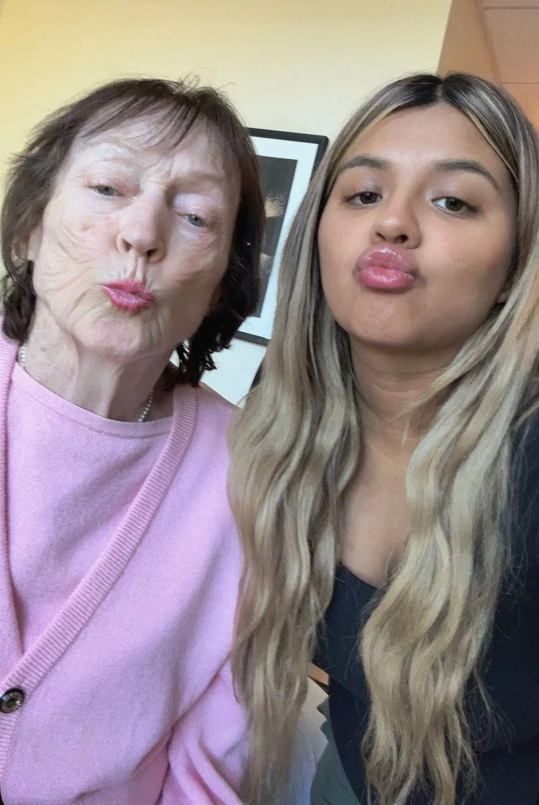 Two women pouting in a selfie, one appears to be an older woman and the other a young woman.