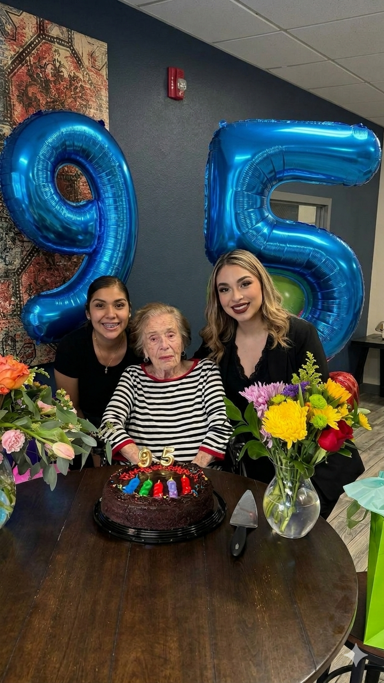 Three women celebrating a birthday.