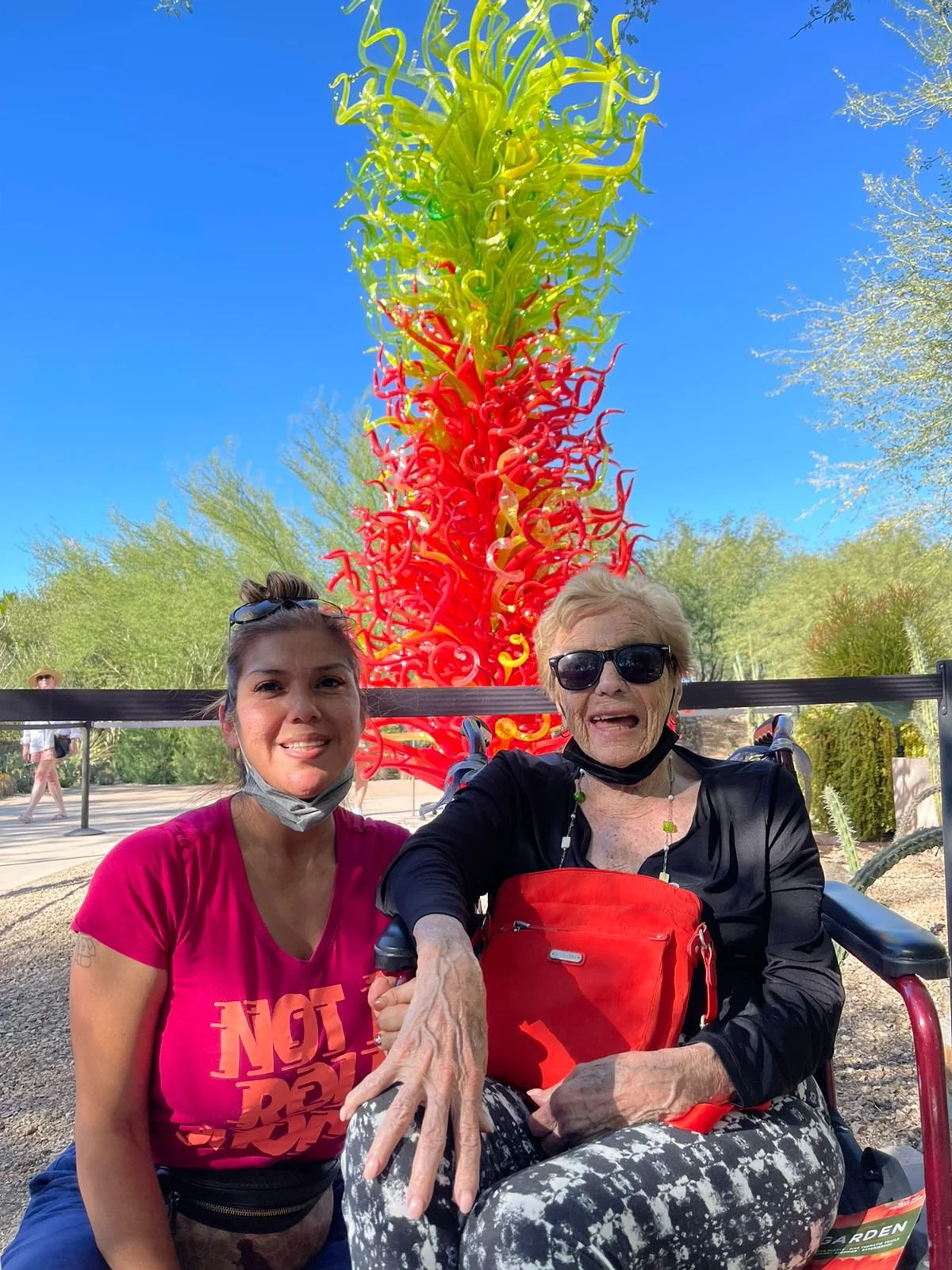 Two women sitting, enjoying the day.