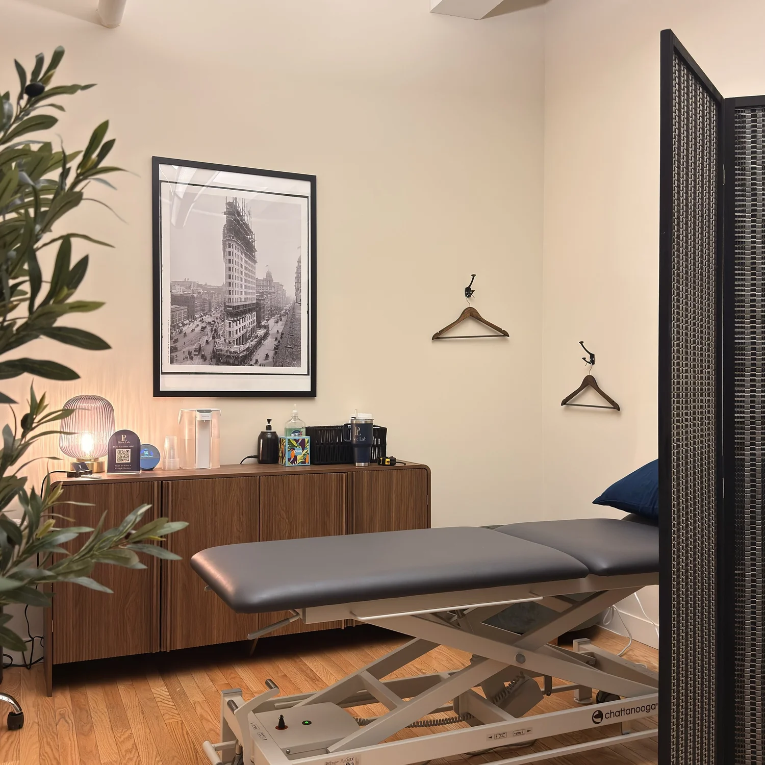 Private treatment room at Pelvic Lab with treatment table and walnut cabinet