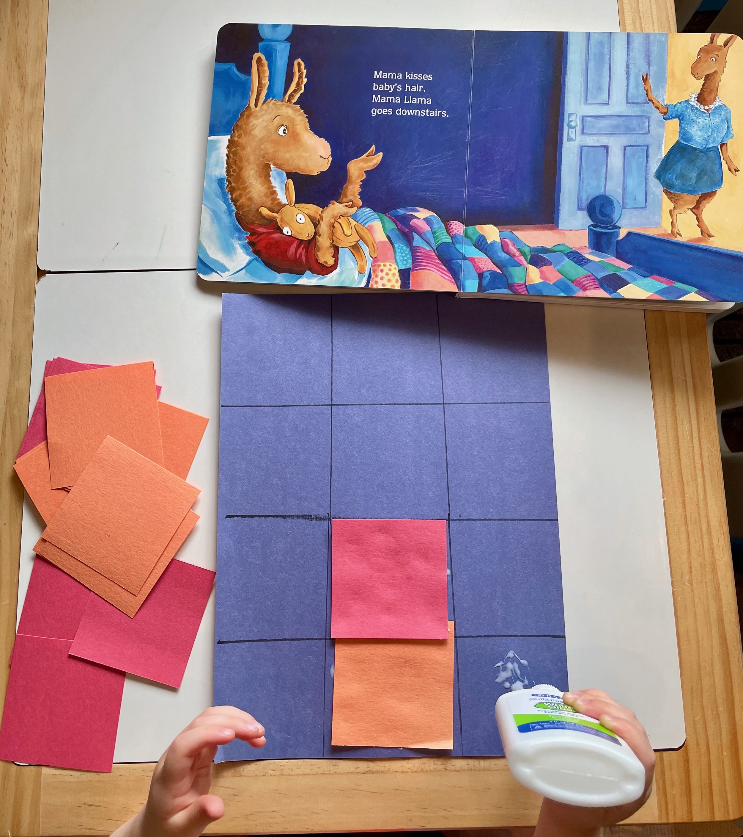 Opened children's book with an illustration of a llama and a bunny, blue dresser, and blue door in the background. The book shows a scene where a llama kisses a baby bunny's hair and then goes downstairs.