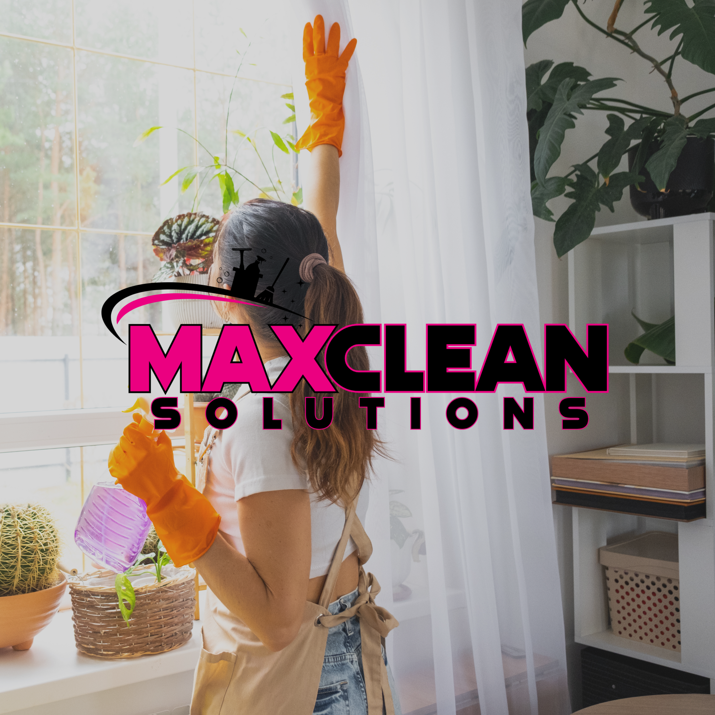 A person with brown hair tied in a ponytail, wearing a beige apron and gloves, watering indoor plants near a large window with white curtains.
