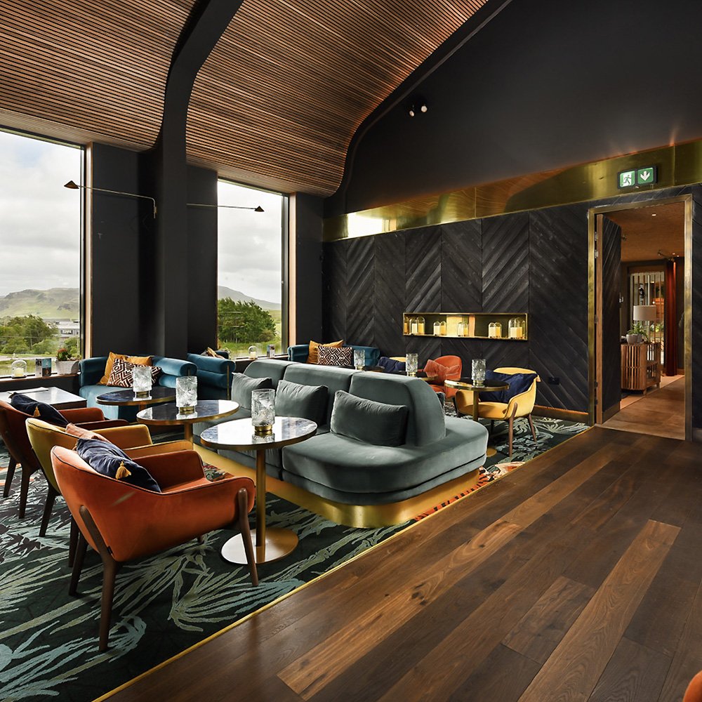 Stylish hospitality lounge interior with panoramic views and modern Scottish design details.