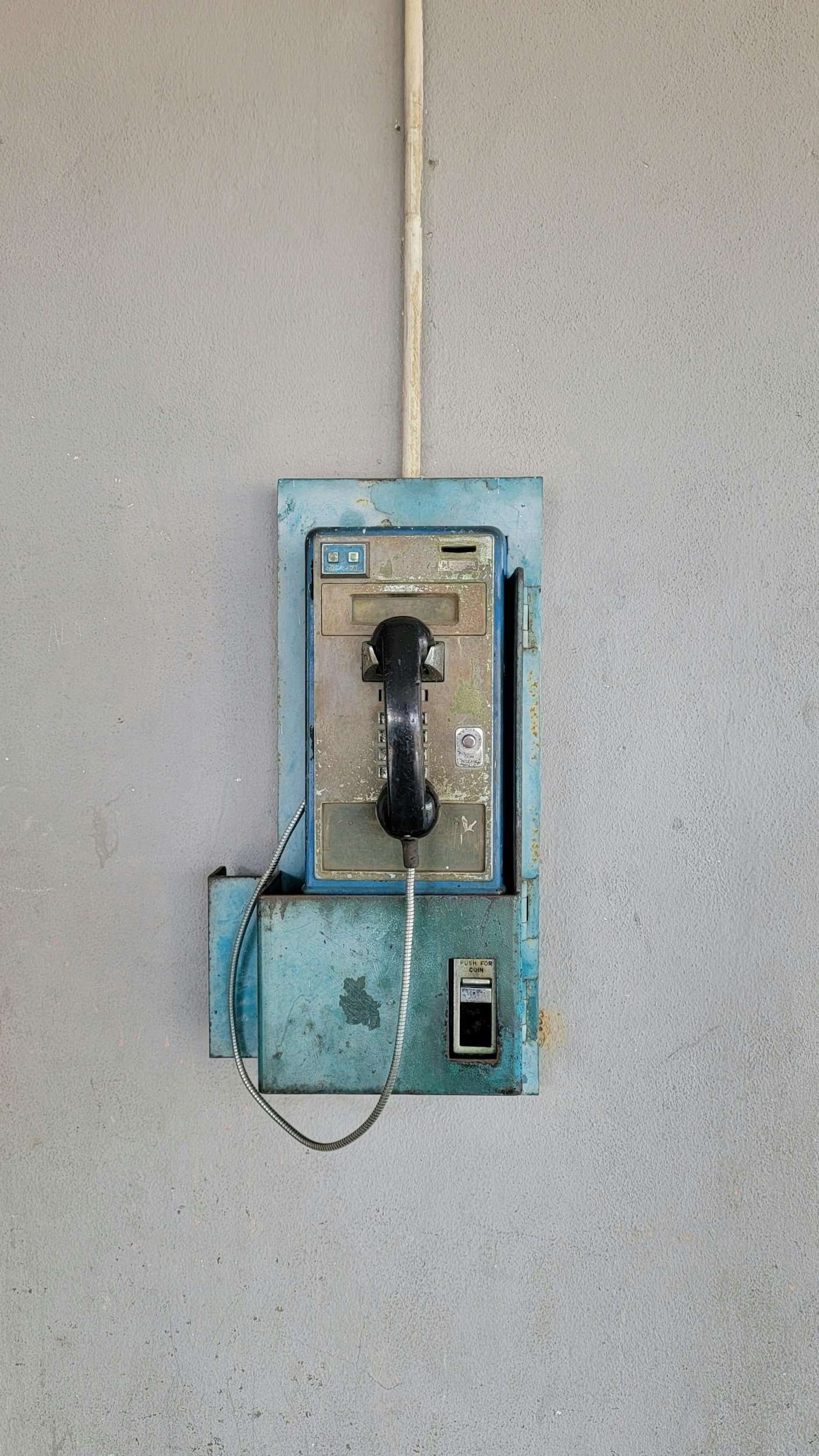 Artistic Photo of a vintage blue payphone