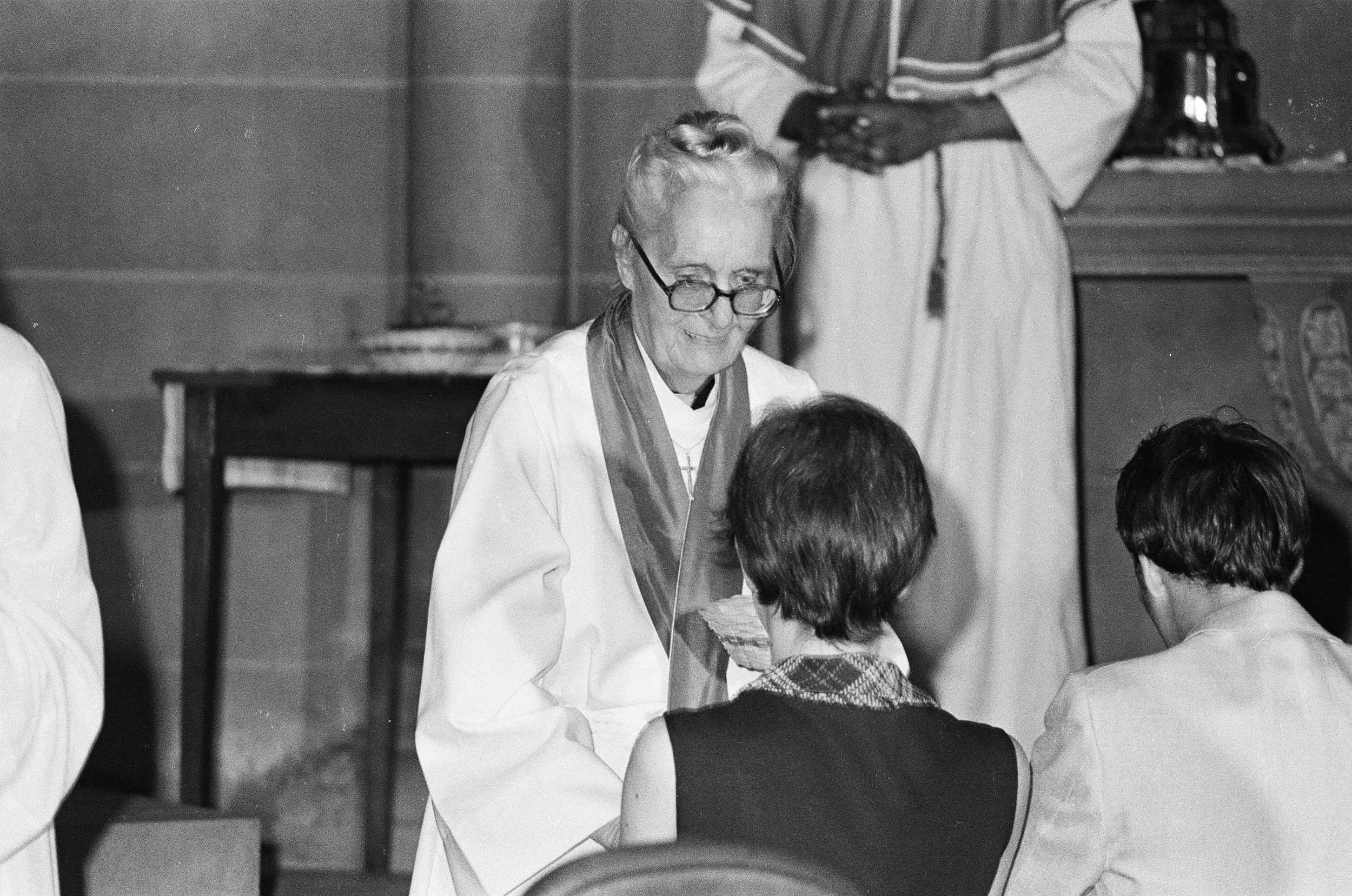 Jeanette Piccard, first woman in space in balloon she piloted, serves Communion after being ordained with 10 other women as first Episcopal priests in the Church of the Advocate, July 1974, Brad Hess photographer