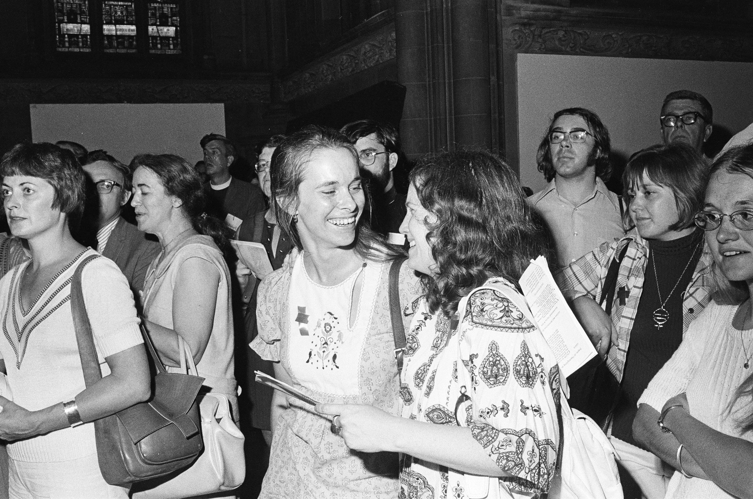 Brad Hess black and white photograph, copyright Darlene O'Dell, Church of the Advocate, Philadelphia Eleven ordinations, July 1974, women priests, Episcopal, large crowd, press, Joyful women in congregation