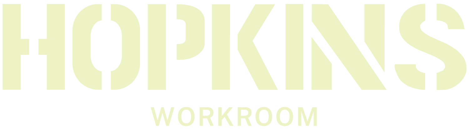 Text saying 'HOPKINS WORKROOM' in neon-style font on a black background.