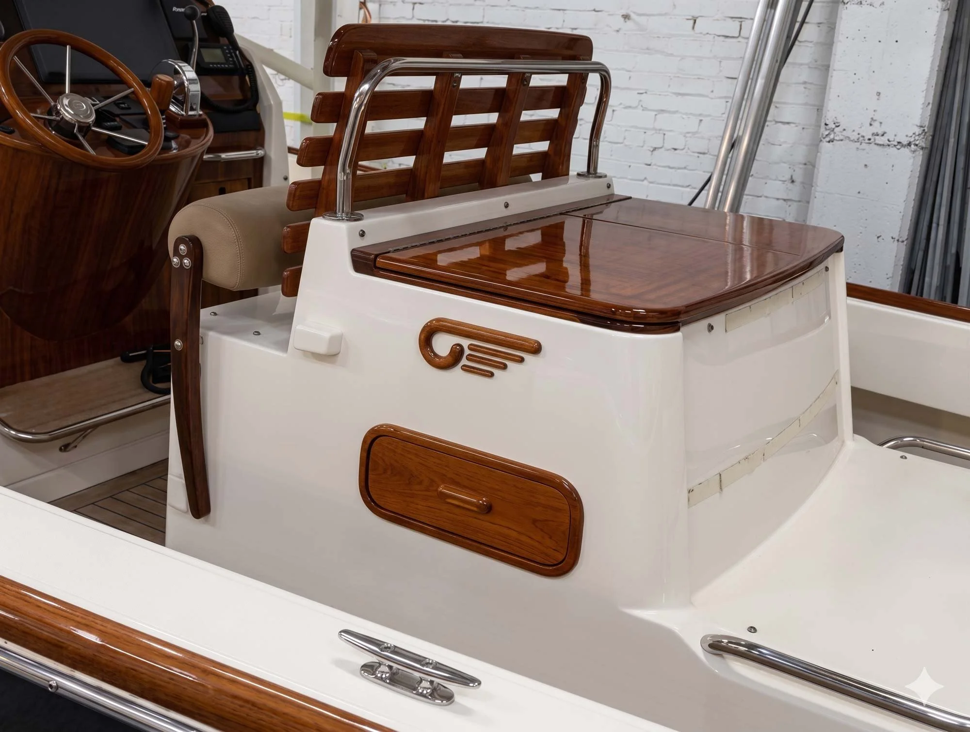 A boat with wooden seats and a steering wheel, featuring metal and wooden accents, docked next to a white brick wall.