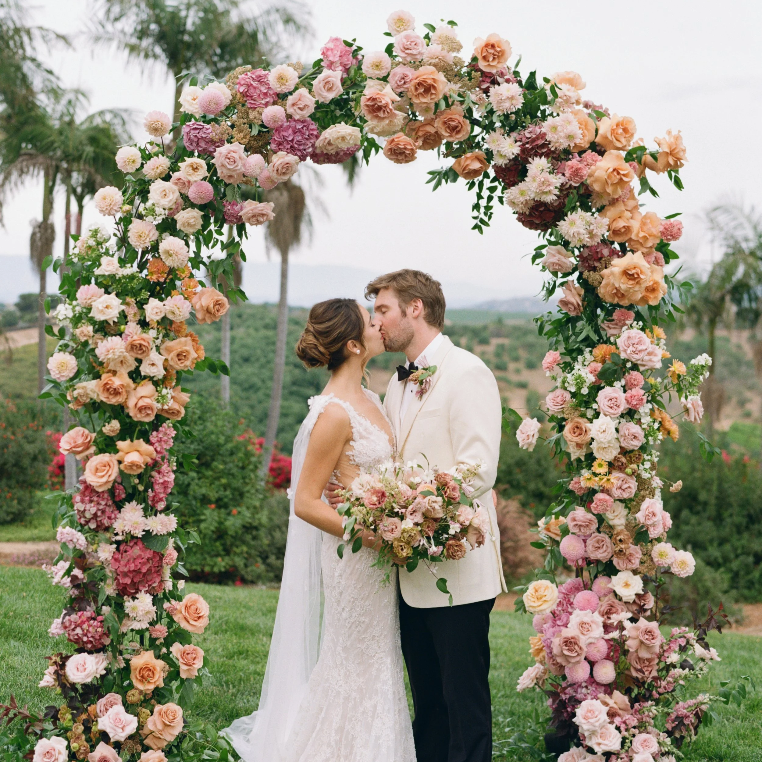 Newlyweds sharing first kiss at Rancho Vera Cruz wedding venue
