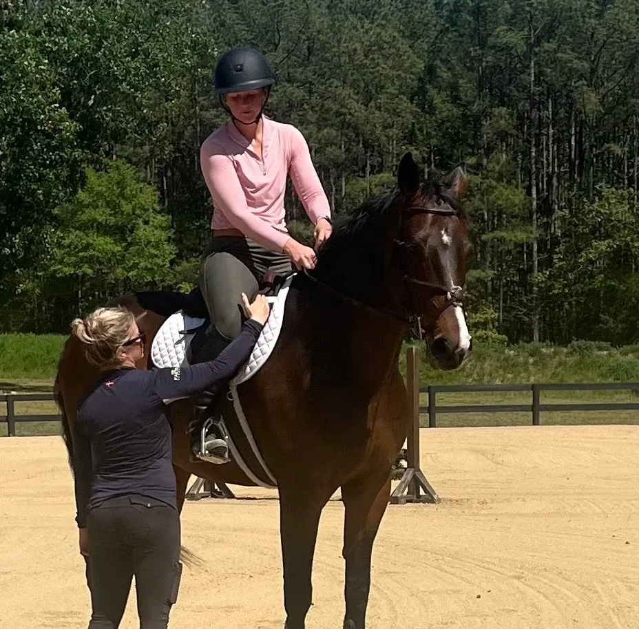 Equestrian specialist Tara Mebane evaluating a horse and rider under saddle to check equipment balance and movement patterns during an Essentials plan session