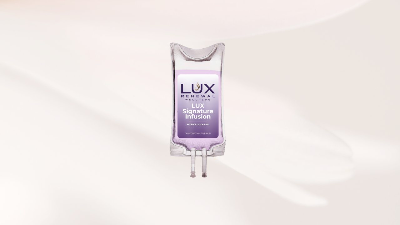 A transparent IV drip bag with a label that reads 'LUX Renewal Wellness' and 'LUX Signature Infusion' against a white background.