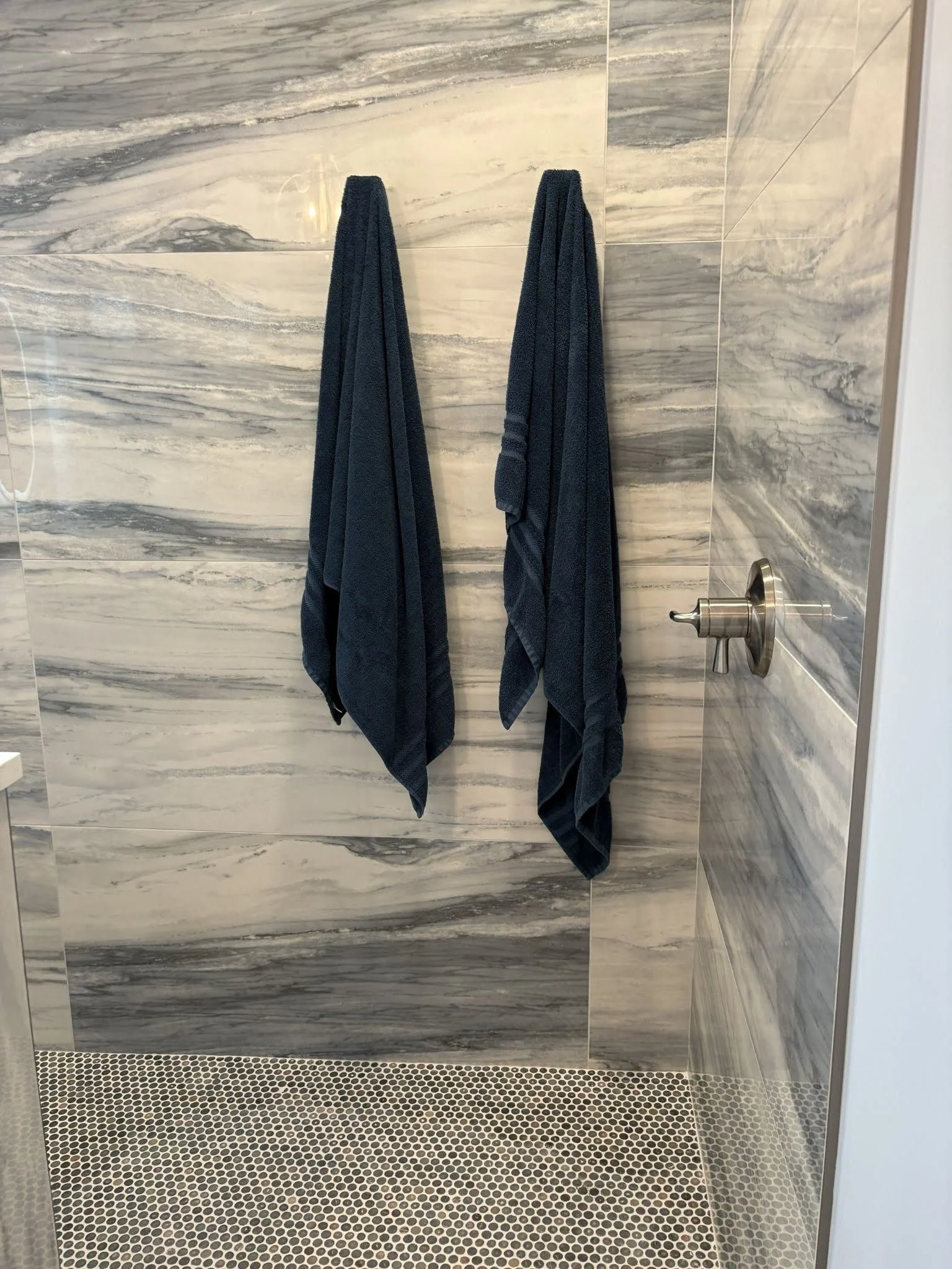 Walk in shower updated with new fixtures towel hooks