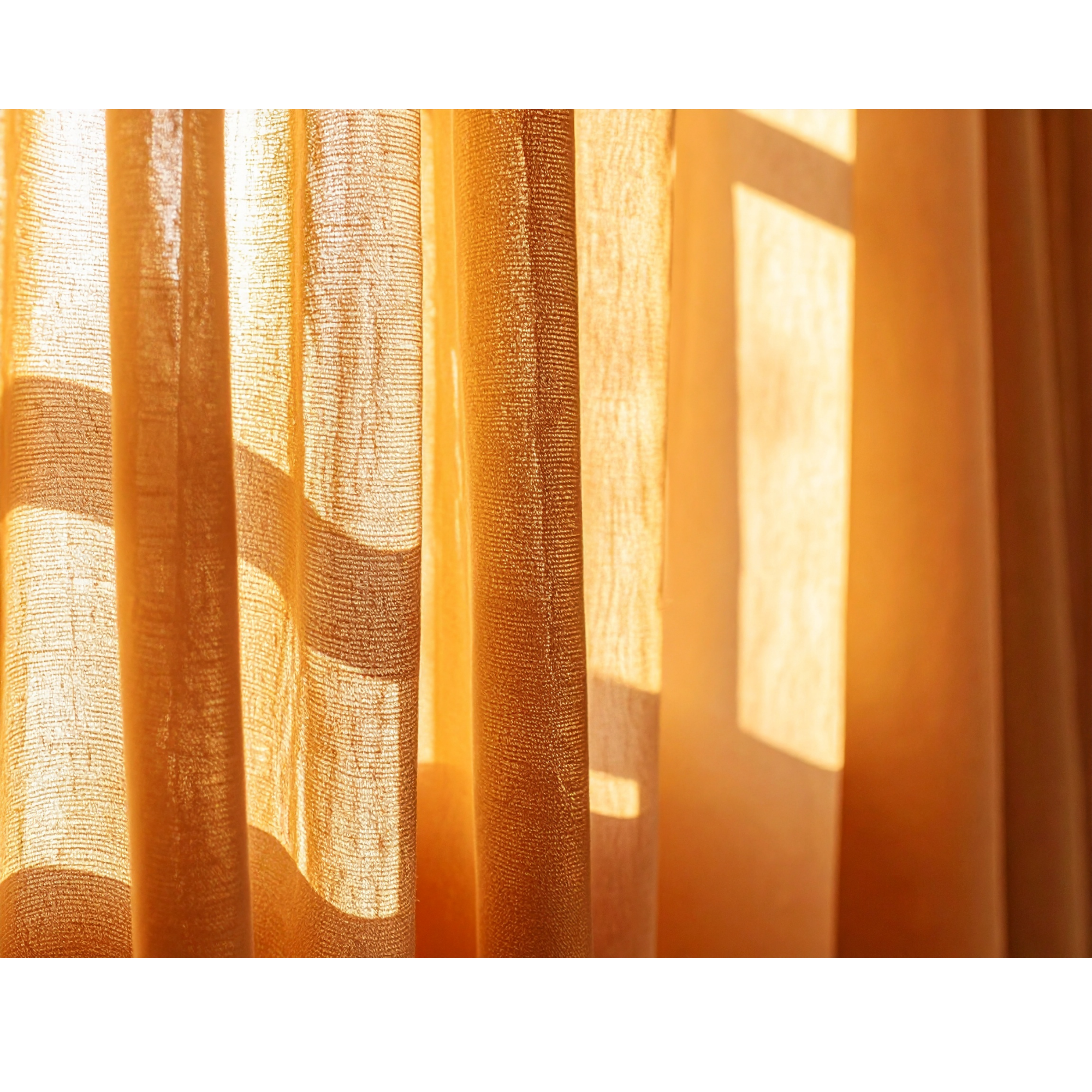 Close-up of sunlight filtering through beige and brown curtains with textured fabric.