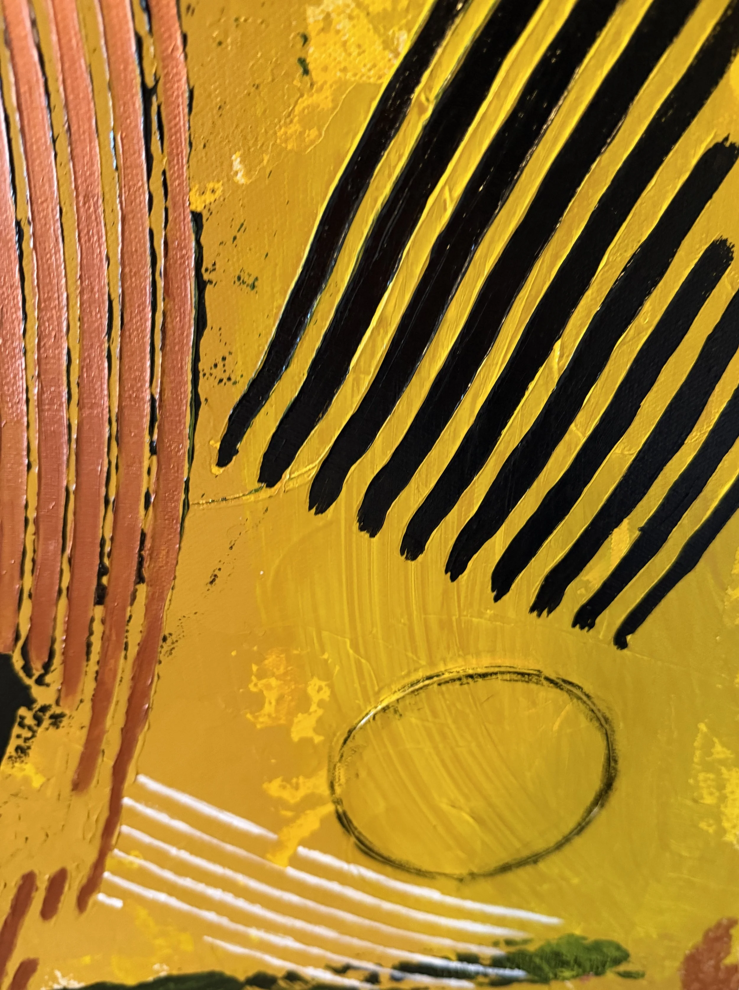 Close-up of a yellow surface with black and pink lines, and some circular and textured patterns.