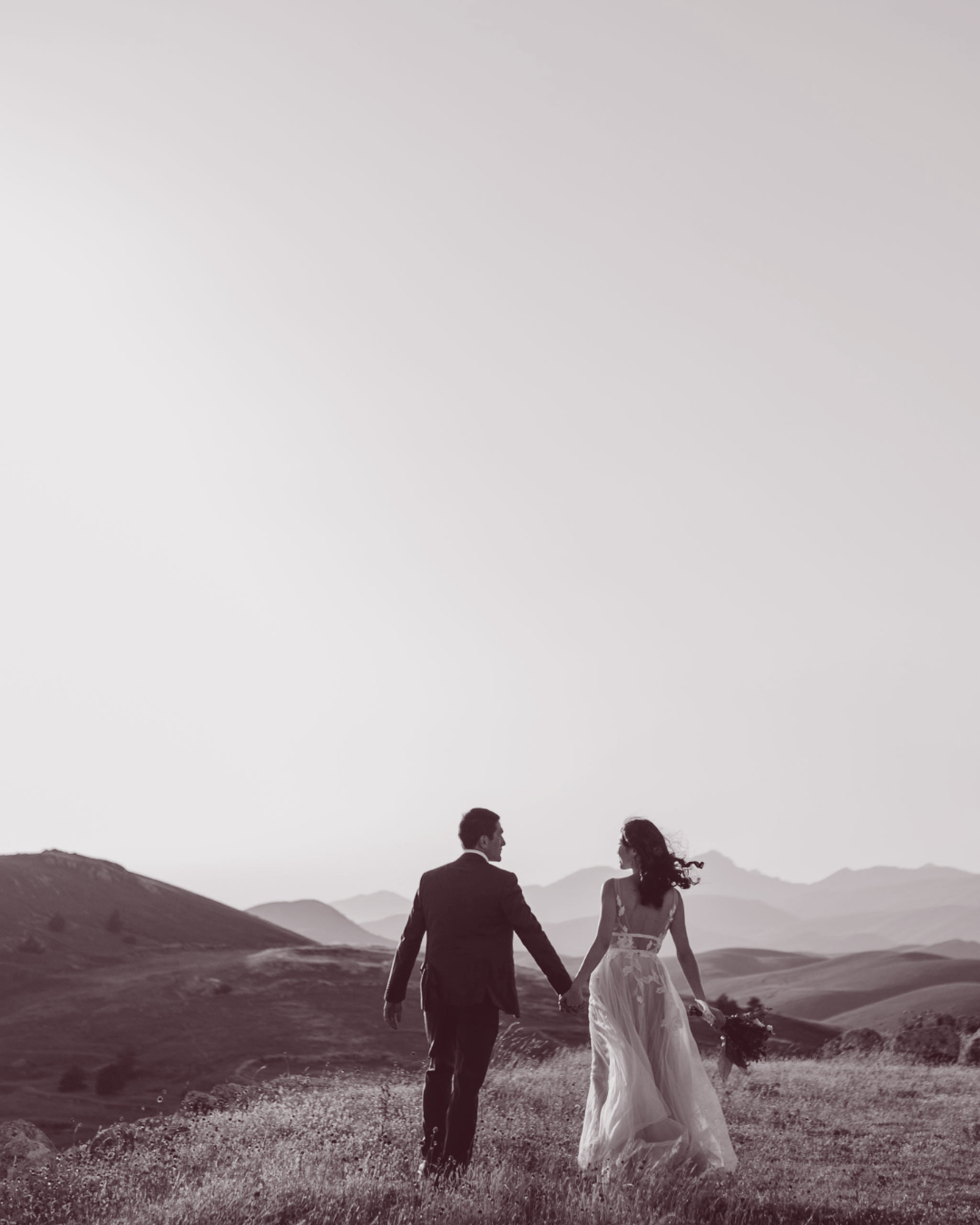Bride and groom walking in New Zealand landscape for wedding video