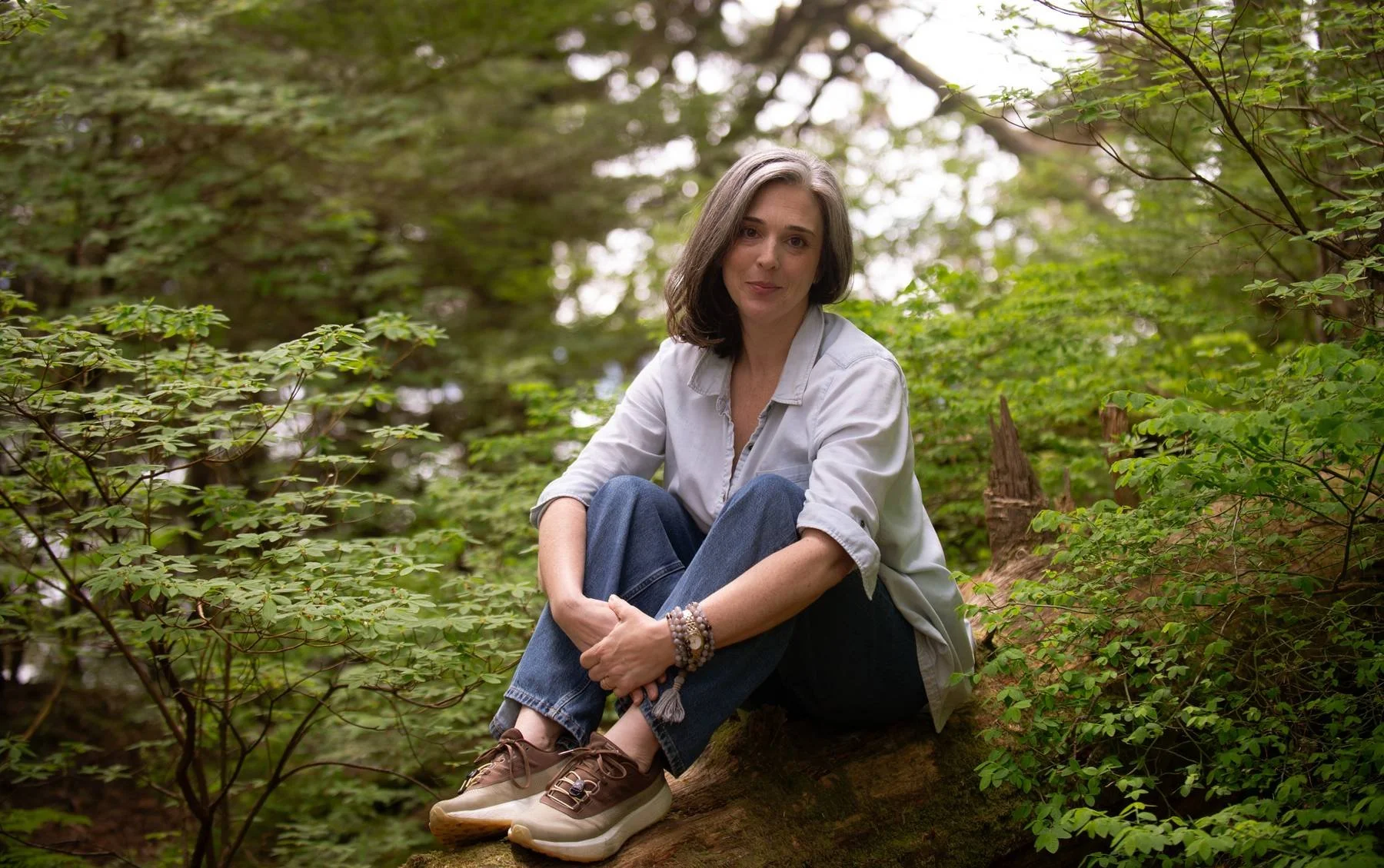 Rachel seated in the Tongass National Forest in Juneau Alaska