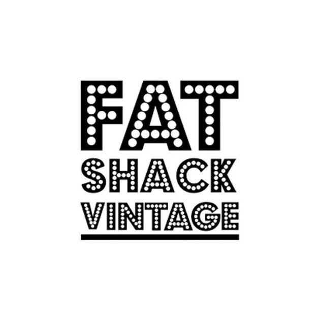 Logo with the words "FAT SHACK VINTAGE" in black text, with 'FAT' in a dotted pattern, 'SHACK' in a stippled pattern, and 'VINTAGE' in a dotted outline, underlined by a black line.