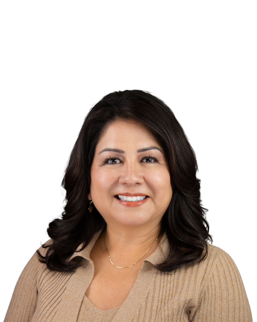 Portrait of a woman with dark brown hair, light makeup, wearing a beige ribbed sweater, gold earrings, and a delicate necklace, smiling against a black background.