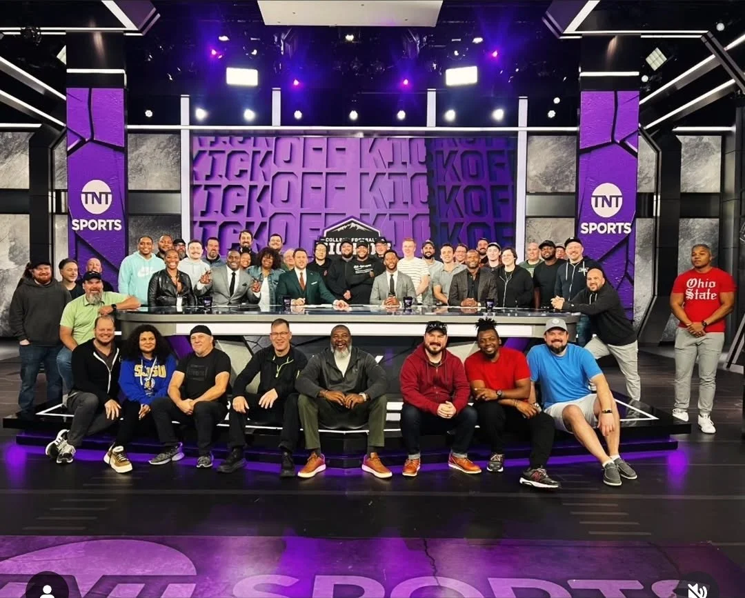 Group of people in a television studio with 'College Football' branding and 'TNT Sports' logos, posing for a photo.