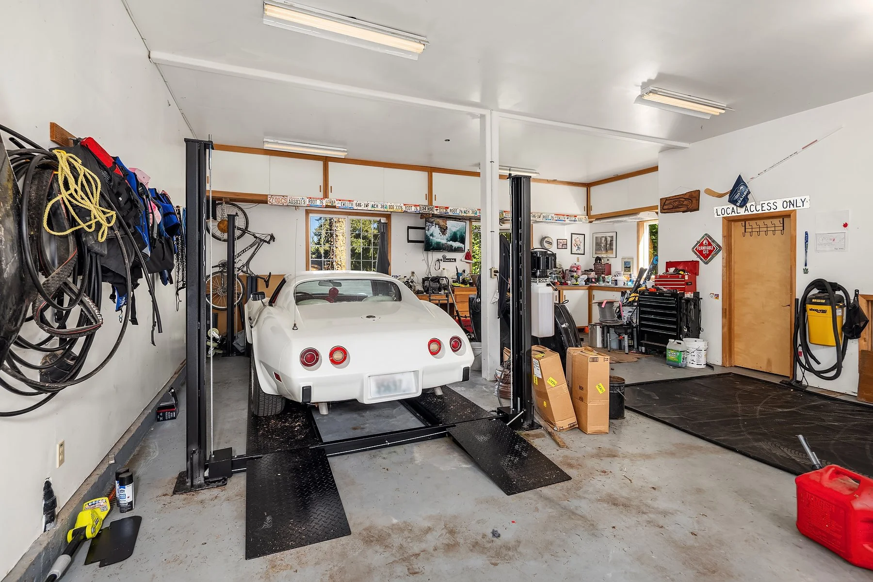 currently able to park 5 vehicles in - there is the ability to add more lifts - the garage has 11' ceilings, workshop & bathroom