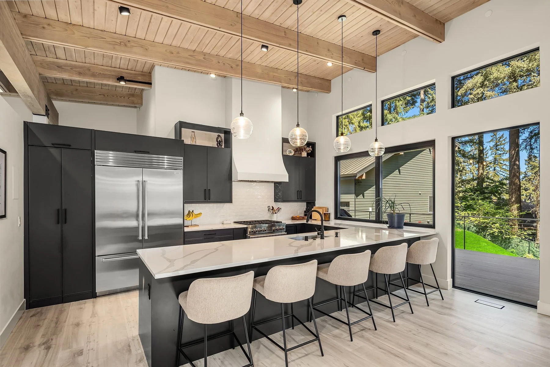 hideaway pantry to the left of the oversized subzero refrigerator - "serving" window designed for a future outdoor kitchen or bar, perfect for entertaining. 