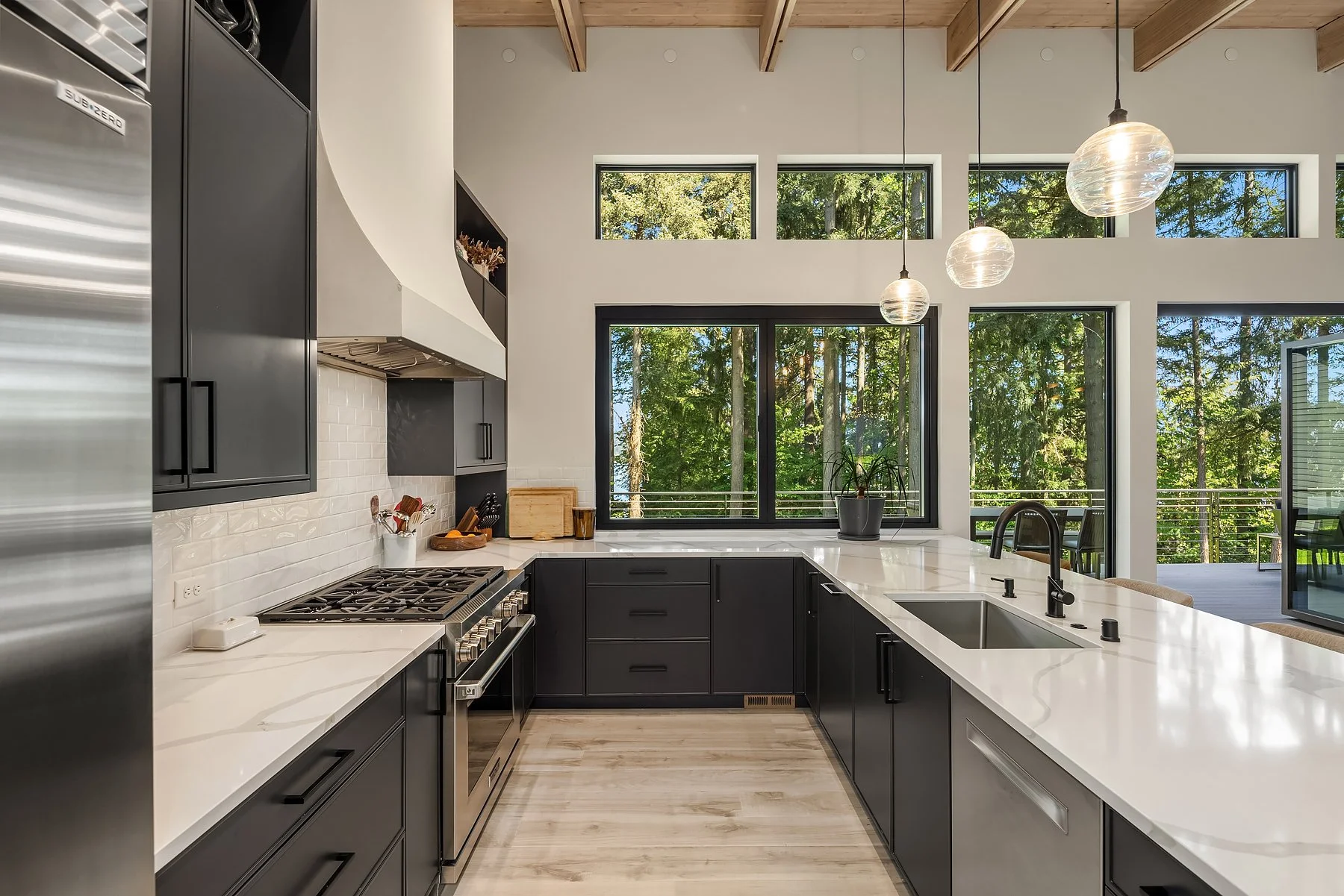 Custom kitchen with hideaway pantry, slab quartz & high end appliances