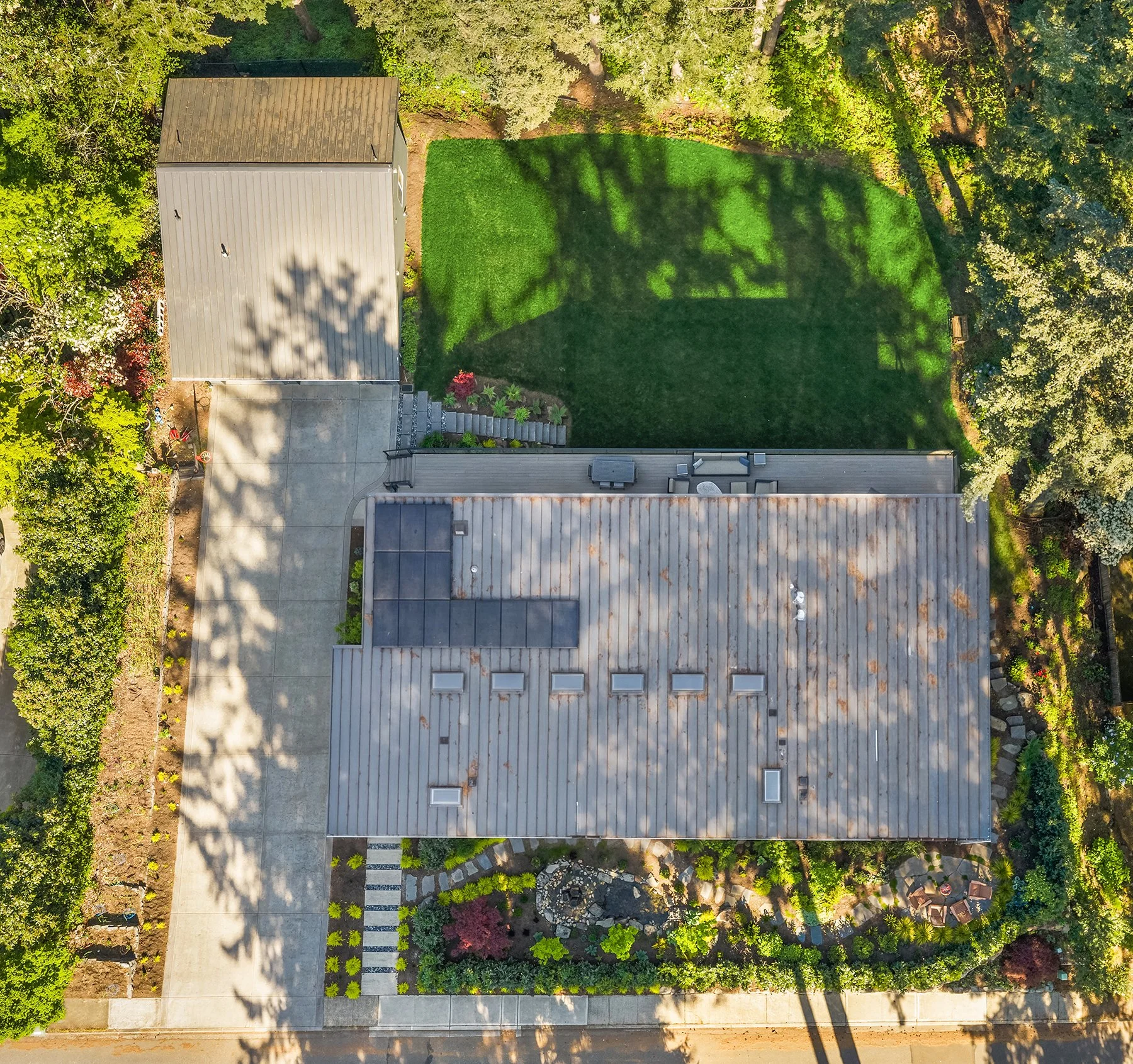 Overview of the property with extra wide drive, garden space, "secret patio", sprawling lawn and solar