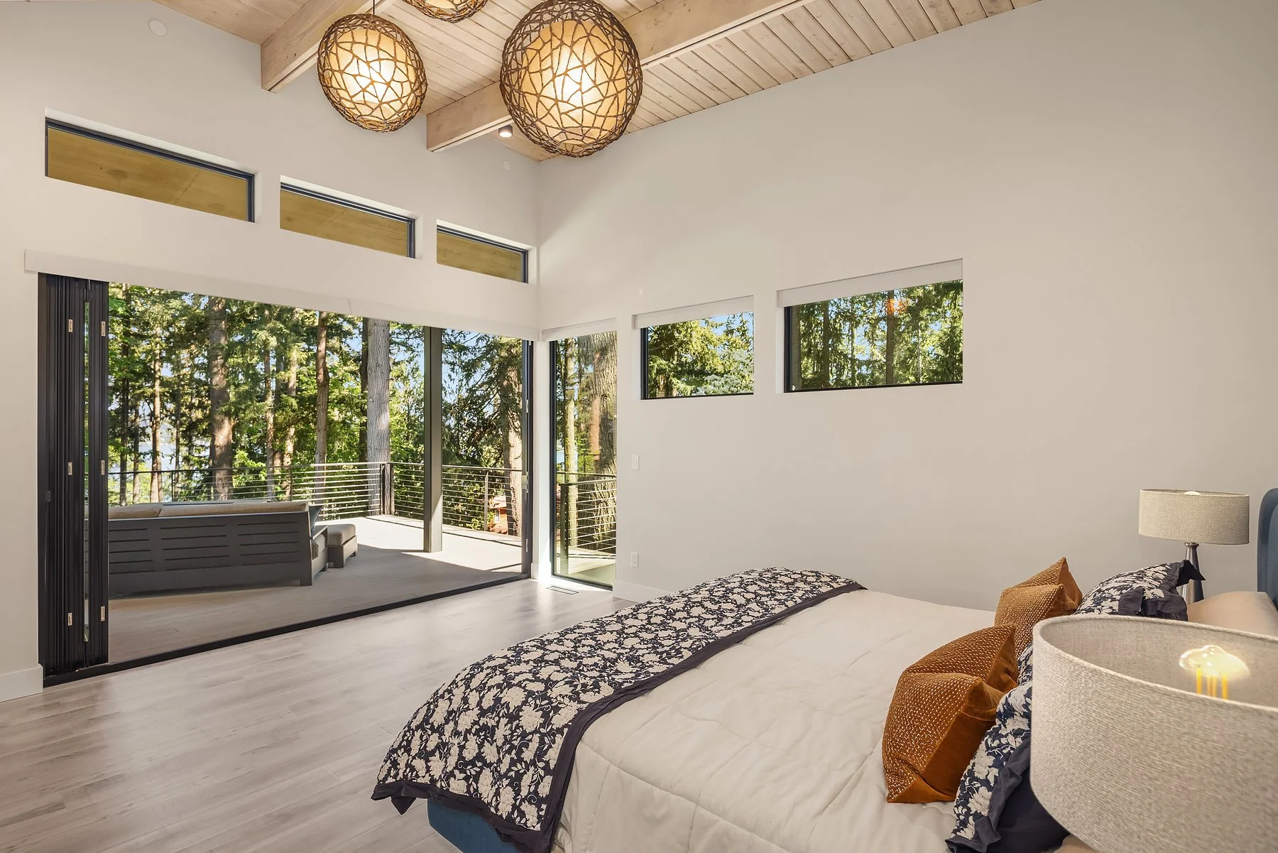 Primary suite is tucked away from the entertaining space, with deck access & views, Catina doors and soaring ceilings