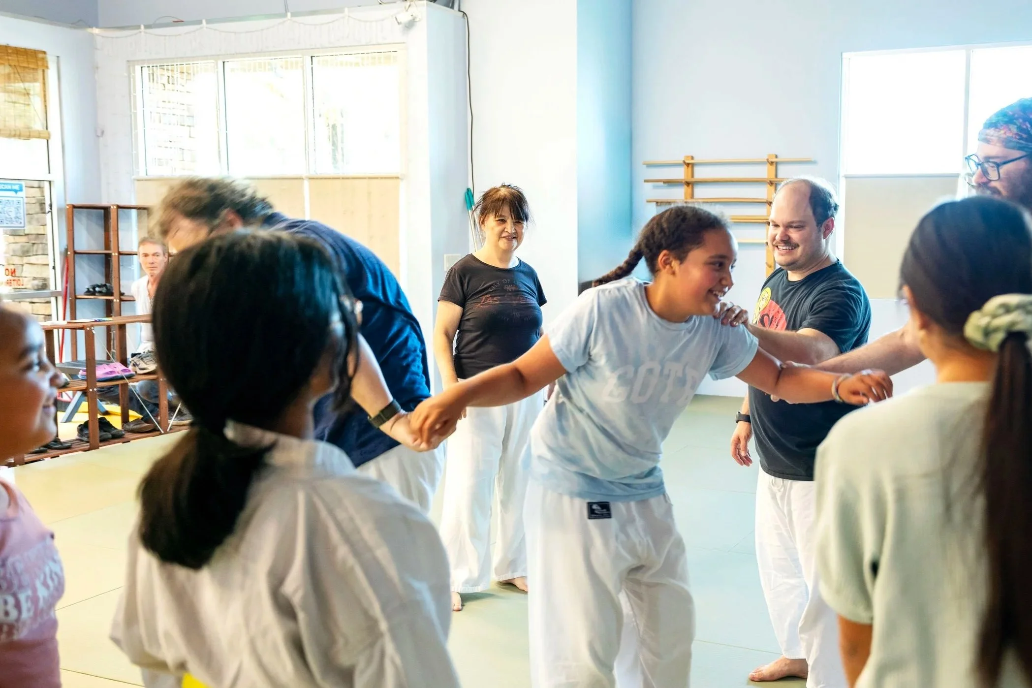 Young students practicing Aikido grabbing techniques together during a children’s martial arts class at Henderson Aikido & Yoga.
