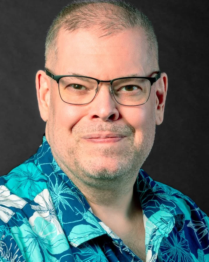 Middle-aged man wearing glasses and a Hawaiian shirt