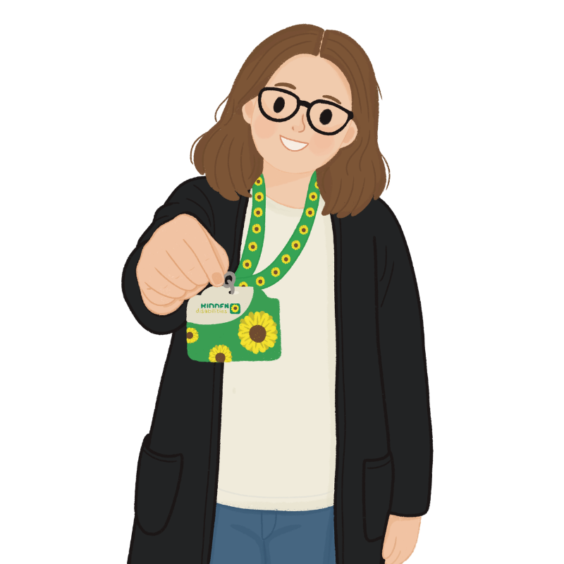 A woman with glasses and brown hair smiling and holding a sunflower-themed badge at a disability event.