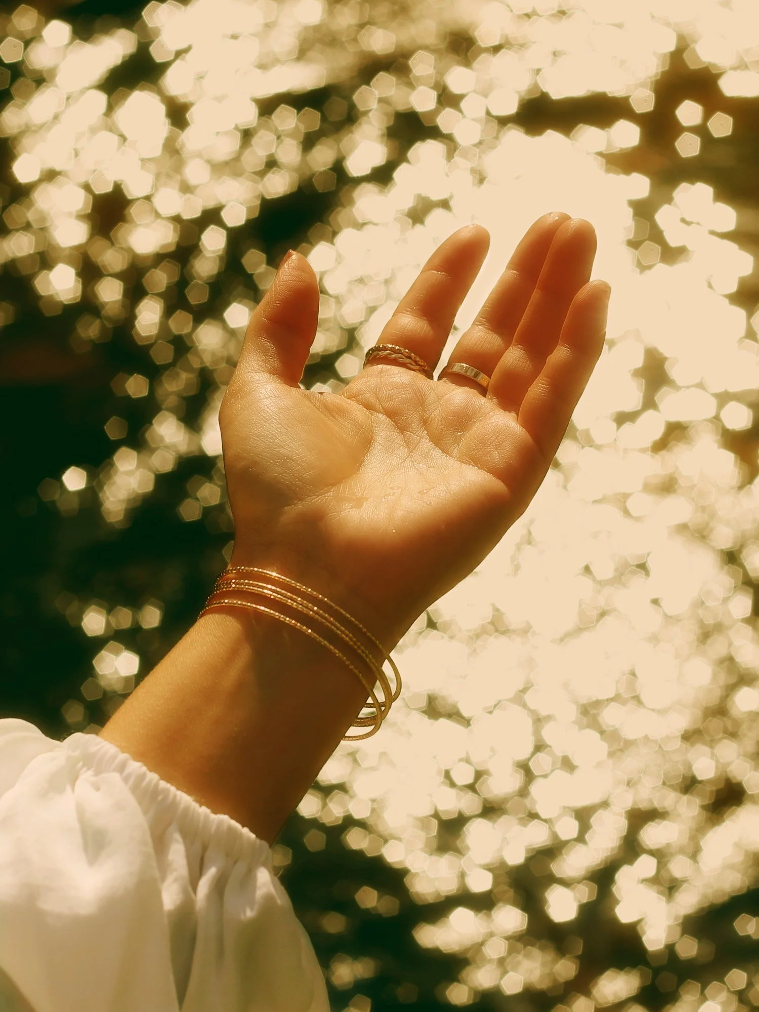 Hand in sun with water sparkle
