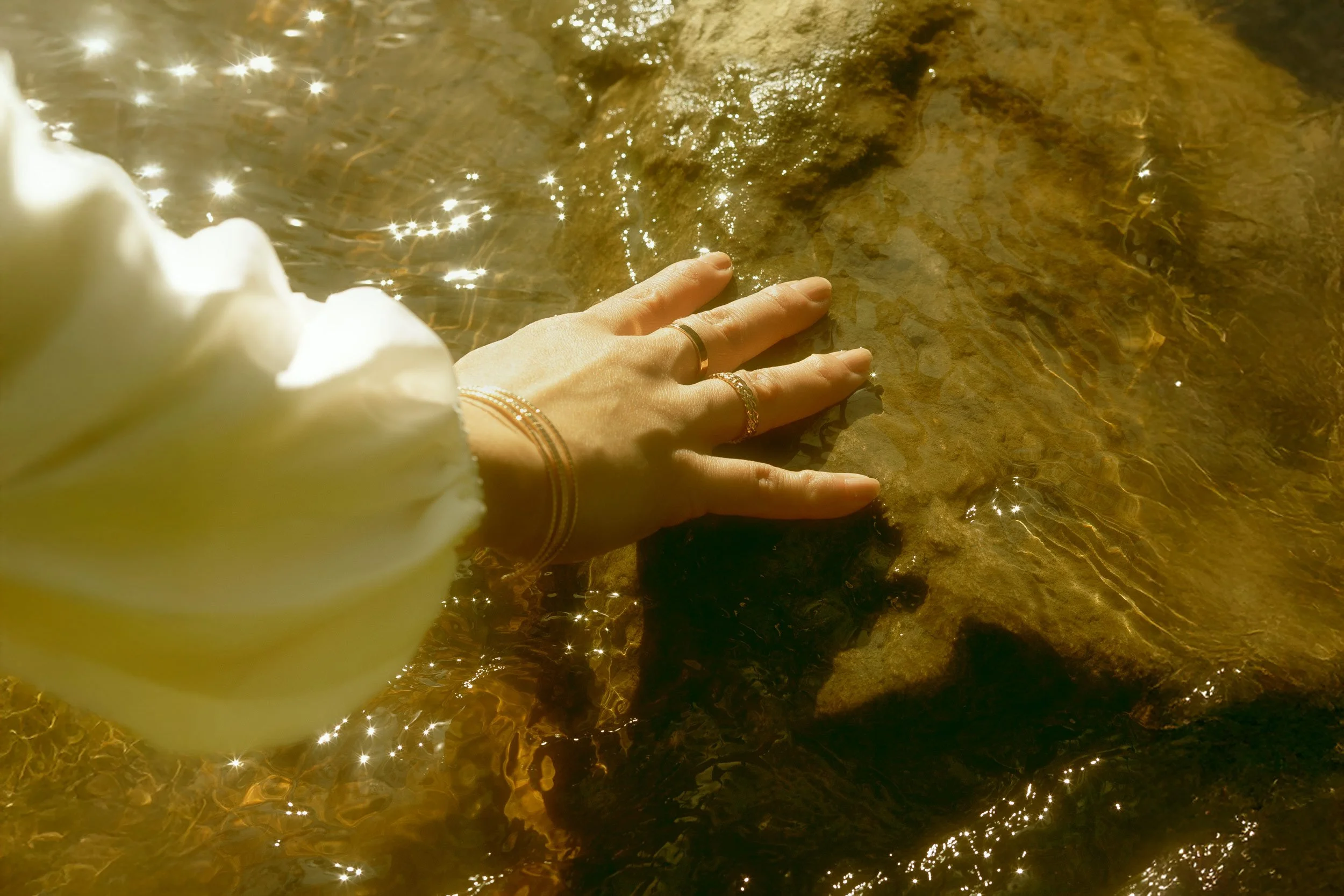 Hand on rock on water