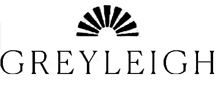 Silhouette of a person climbing a mountain at sunrise or sunset.