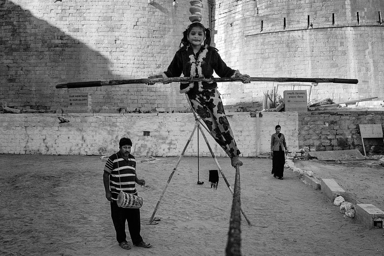 Black and white photo of a street performer in India