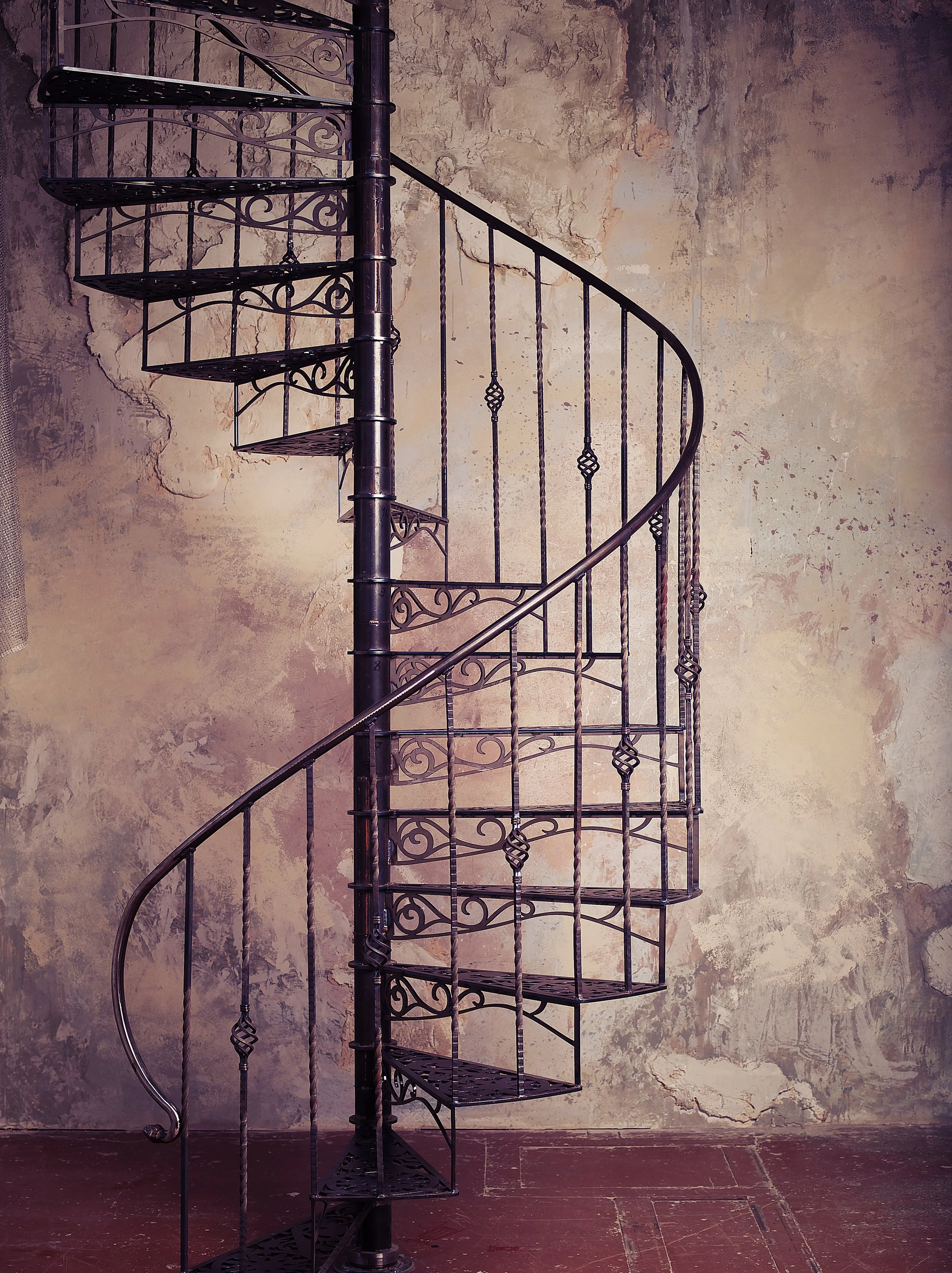 metal-spiral-staircase-against-old-wall-background.jpg