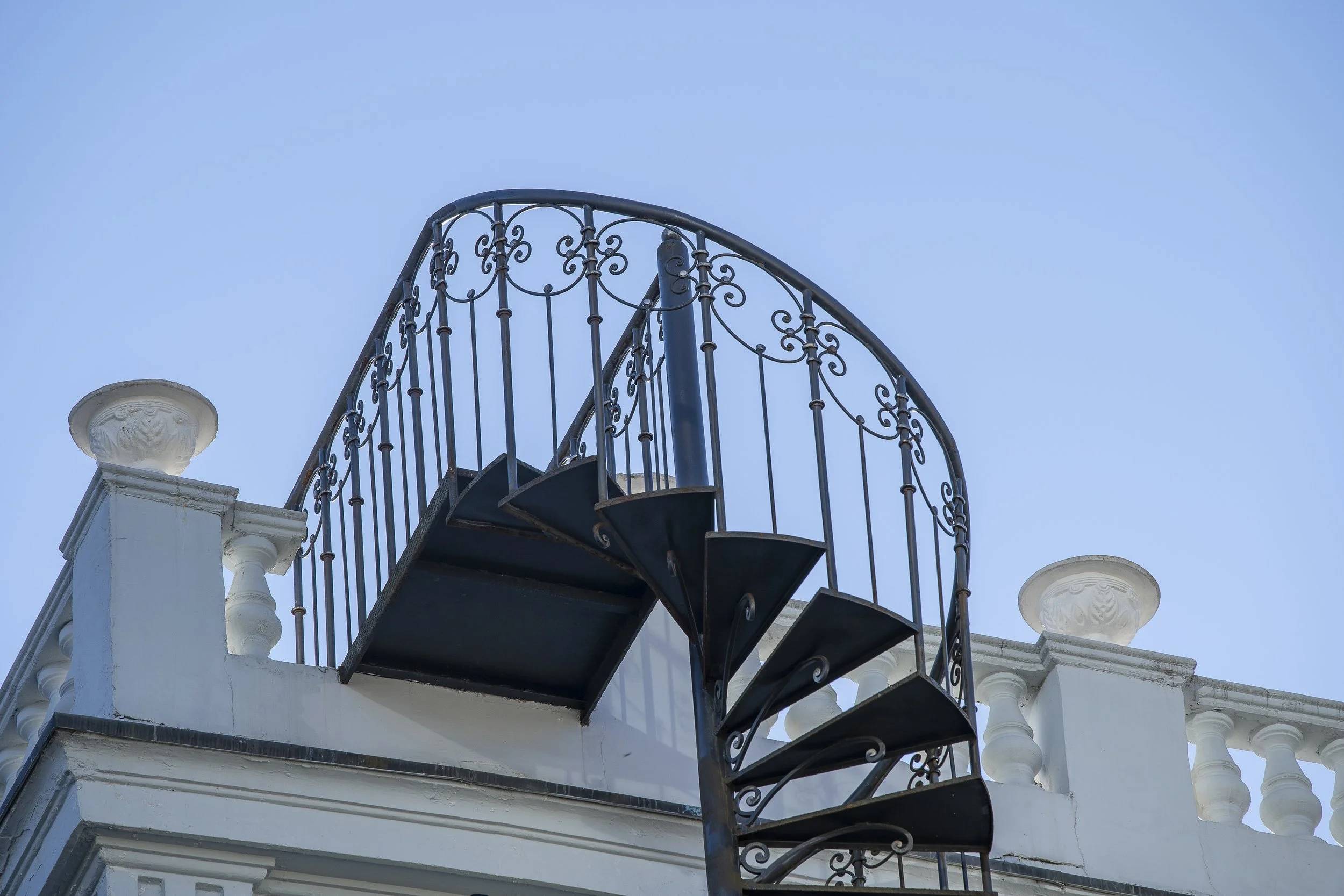 close-up-beautiful-wrought-iron-exterior-spiral-staircase-side-house.jpg