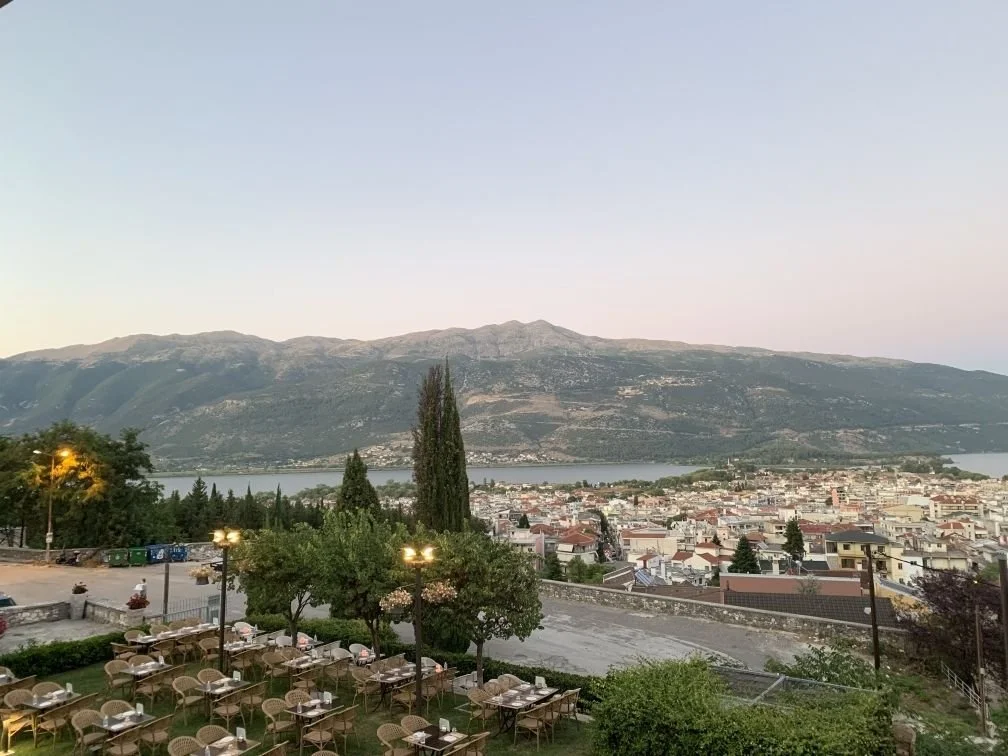 Ioannina, Greece — lakeside city surrounded by mountains at dusk
