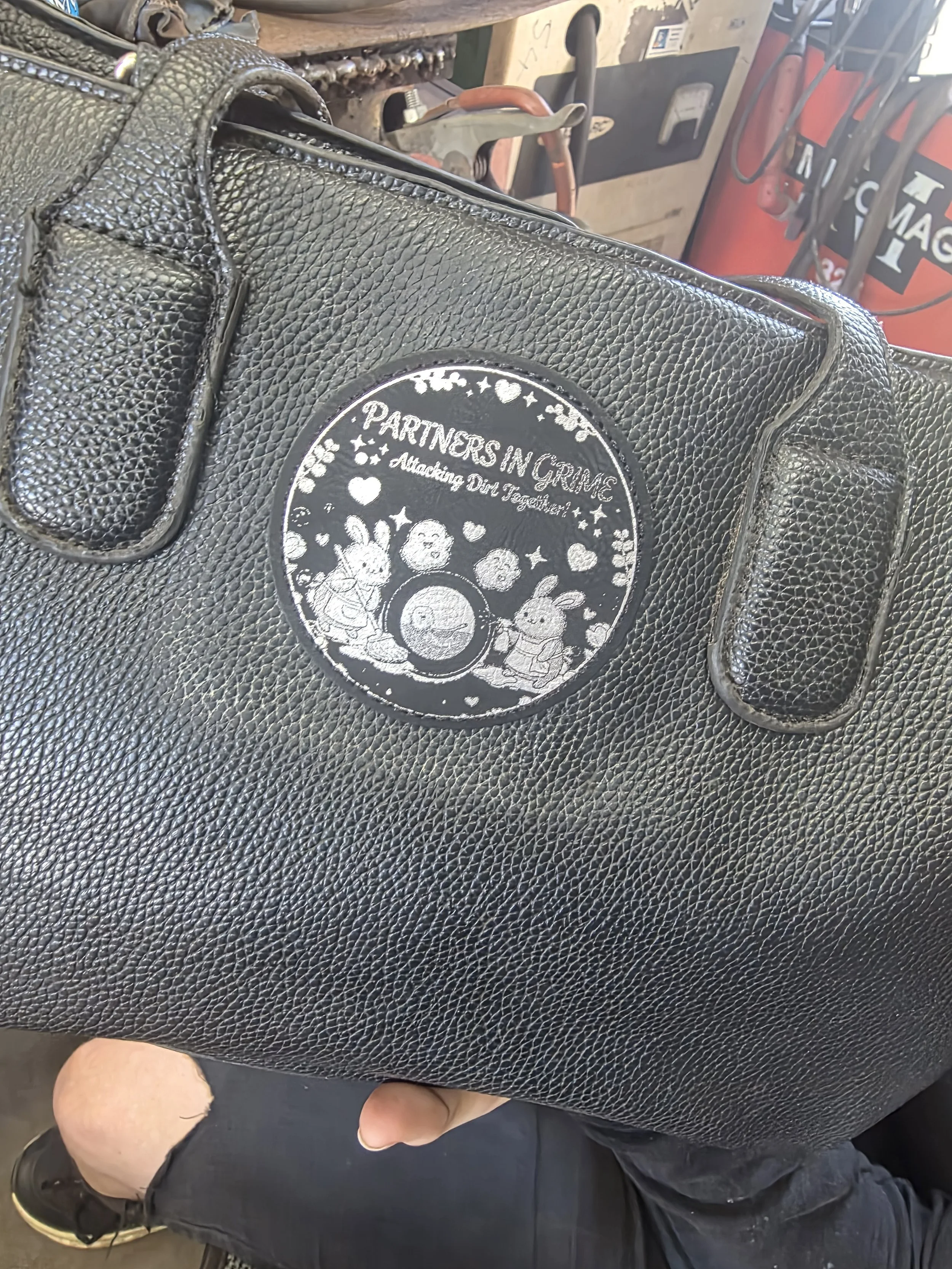 Black/Silver Leatherette patch attached to bag