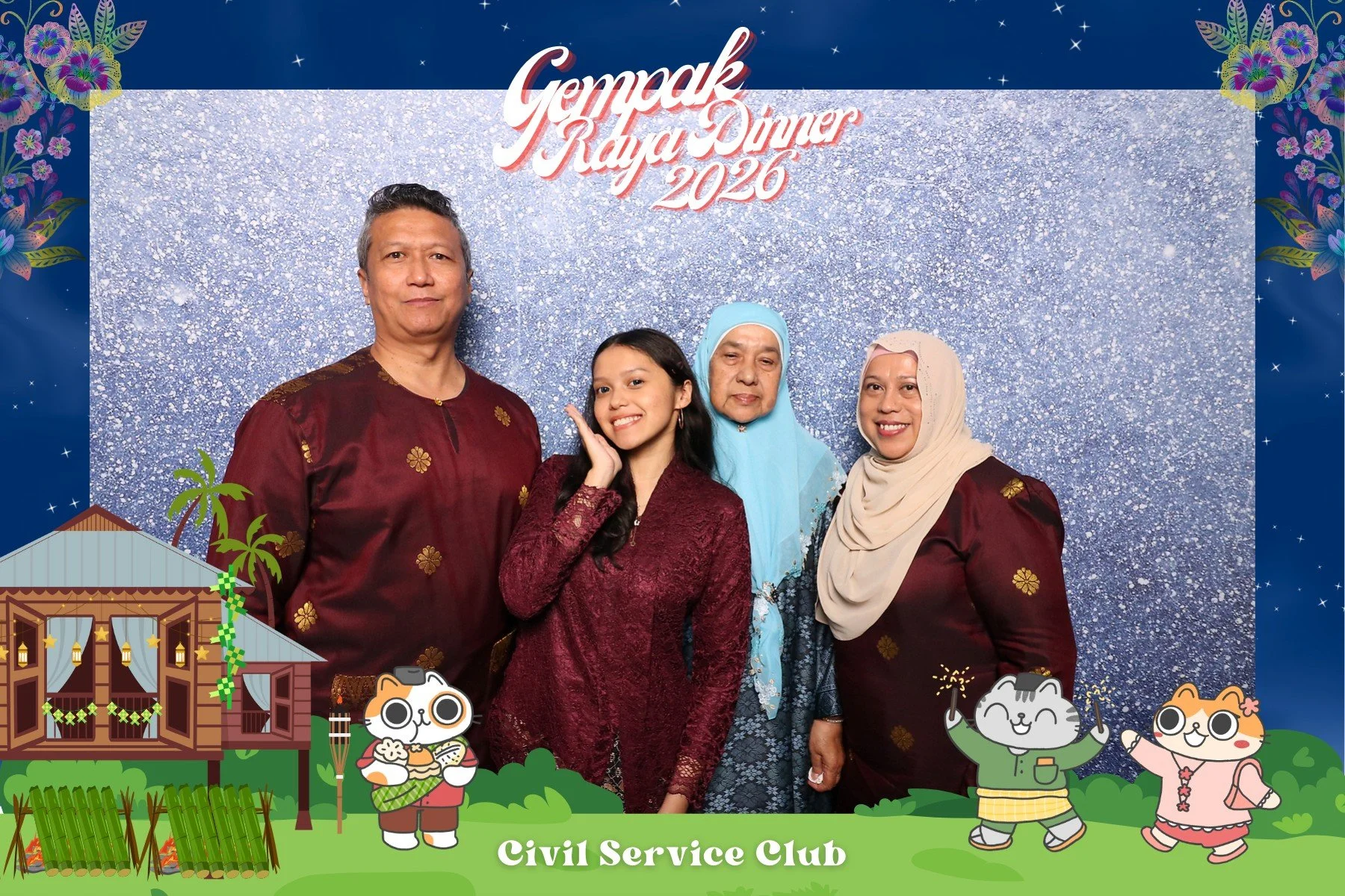 A family posing for a photo at a Gempak Raya Dinner 2020 event, with a blue sparkling backdrop and colorful cartoon illustrations of a traditional house, cats, and children in traditional clothing at the bottom.