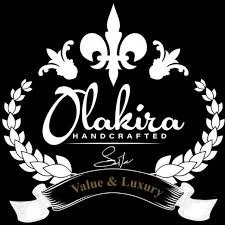 Logo for Olakira Handcrafted with a fleur-de-lis at the top, surrounded by a laurel wreath and a ribbon with the text 'Value & Luxury'.