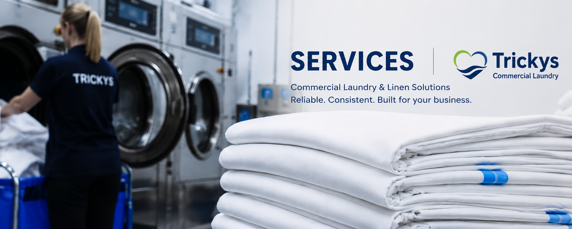 A woman working in a commercial laundry with large washing machines, folded white linens, and a sign displaying 'Services: Commercial Laundry & Linen Solutions, Reliable. Consistent. Built for your business,' alongside the Tricky's logo.