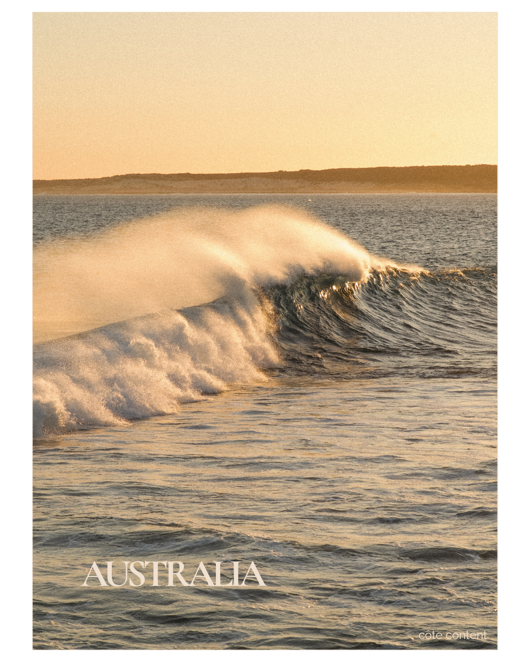 Ocean waves crashing with a distant shoreline at sunrise in Australia.