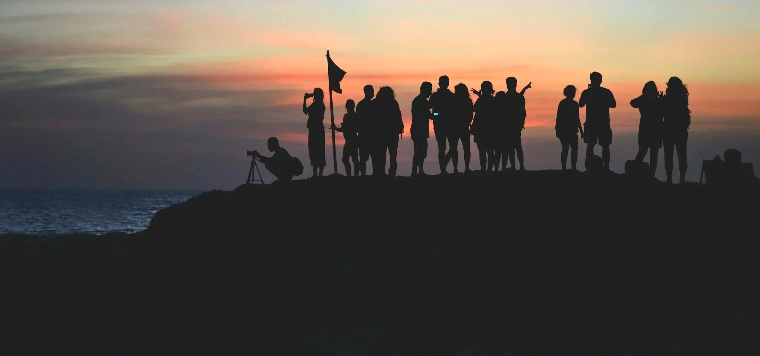 Group of youth standing on mountaintop symbolizing leadership growth and community impact
