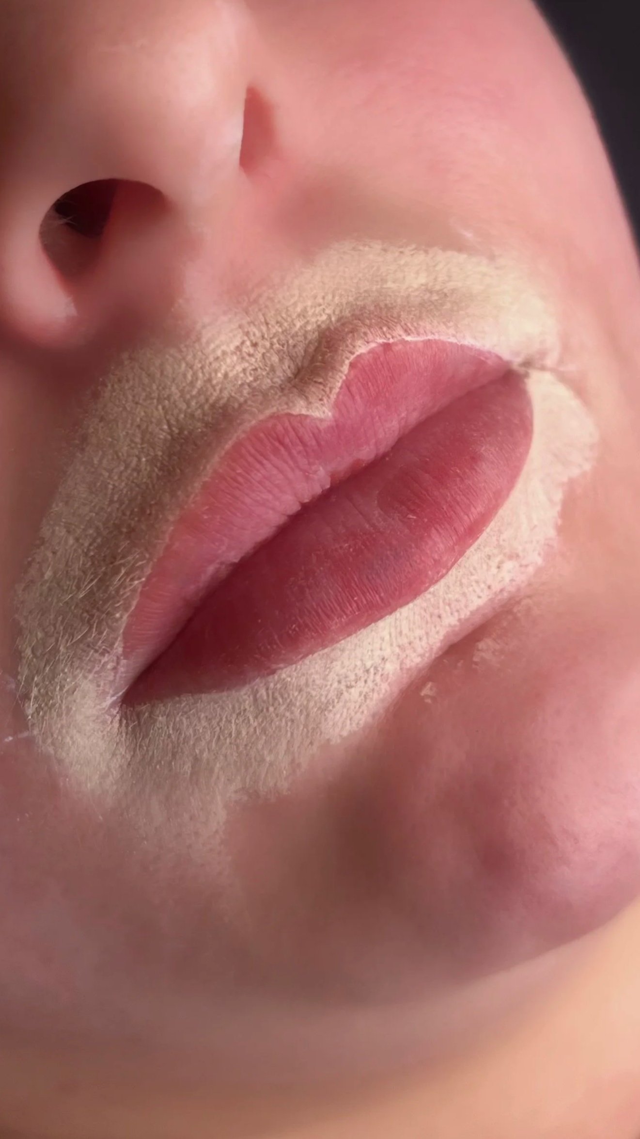 Close-up of a person's face showing a nose, lips, and part of a beard. Lip Blush