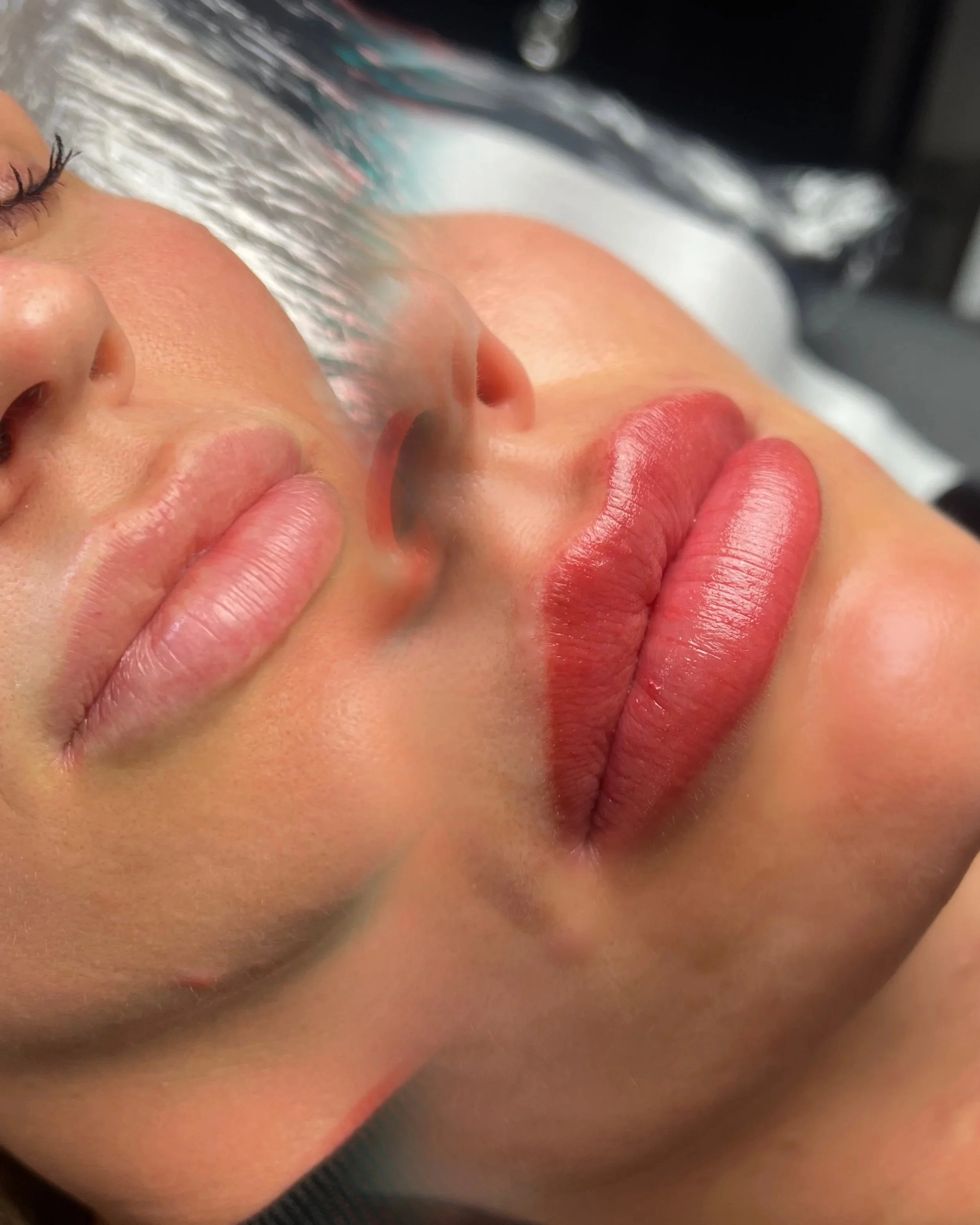Close-up of a woman's face, with her lips pressed against someone's fingers, eyes closed, possibly during a facial treatment in a spa or skincare setting. Lip Blush, Before and after