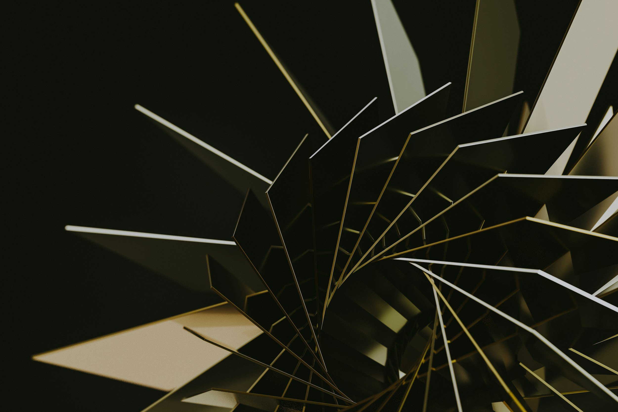 Close-up of a modern artistic or architectural structure with black, white, and gold angular elements creating a spiral pattern.