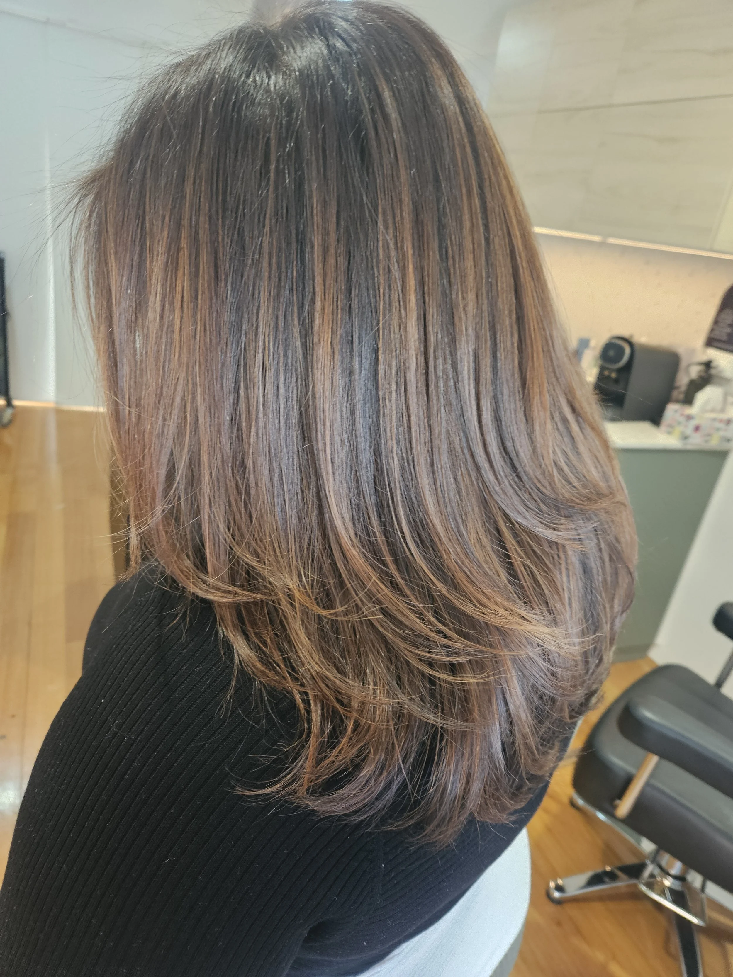 Layered haircut with blonde highlights and soft styling at Jazz Up Your Hair in Eagle Vale Sydney.