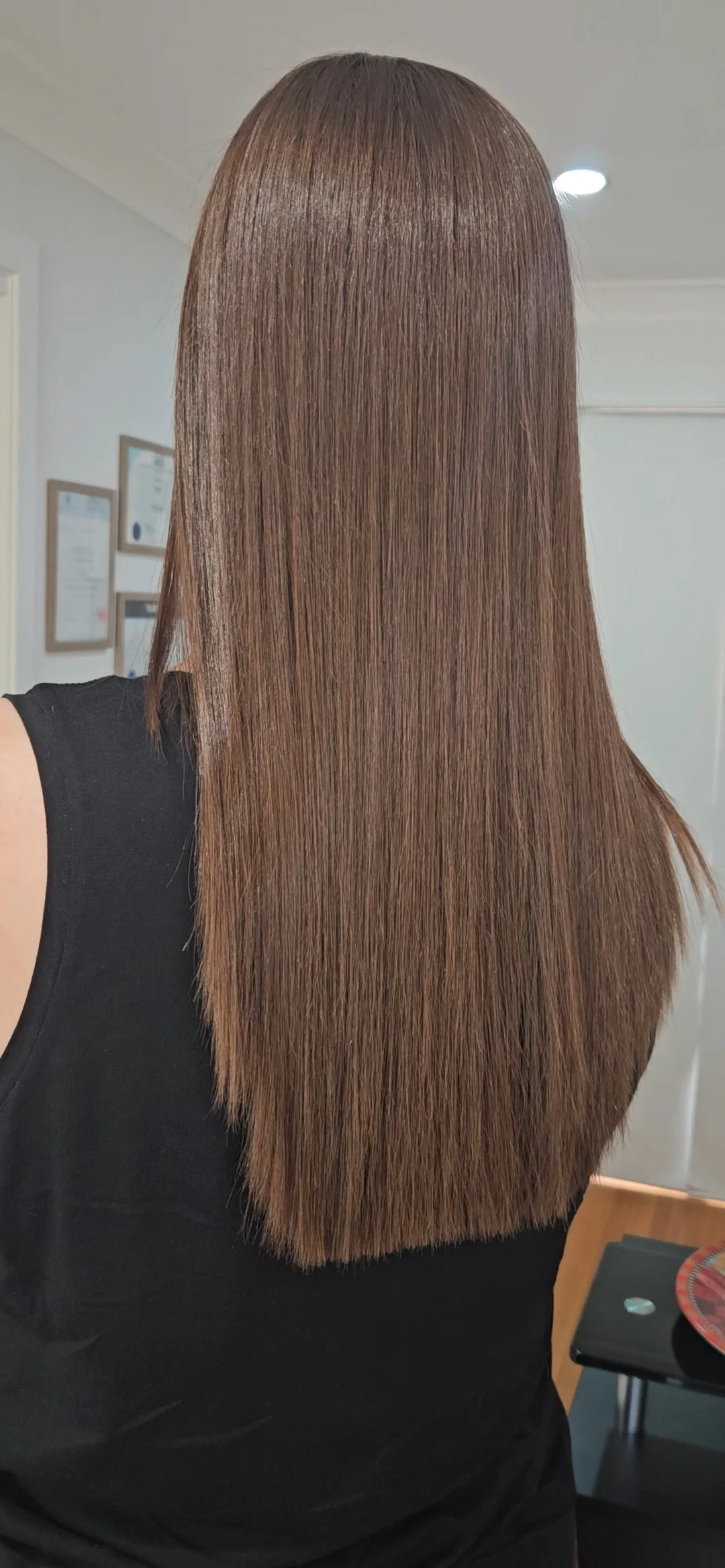 Sleek long brunette hair styled at Jazz Up Your Hair in Eagle Vale Sydney.